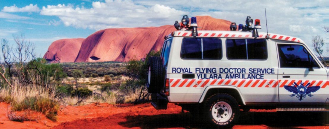 Brad Murphy’s Royal Flying Doctor Service ambulance in Mutijulu, with Uluru in the background